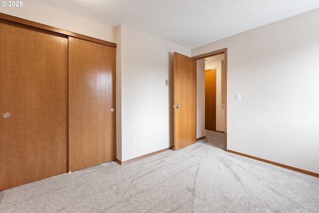 251 NE Village Squire Ave Unit 15, Gresham, OR 97030 - unfurnished bedroom with light colored carpet, a closet, and baseboards