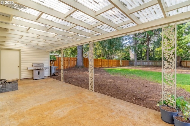 view of patio with area for grilling, a pergola, and a fenced backyard
