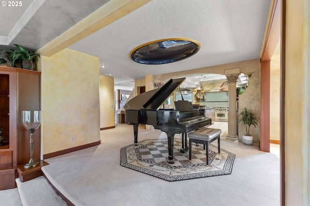6421 Brooklake Rd, Salem, OR 97305 - living area featuring decorative columns, carpet, baseboards, and arched walkways