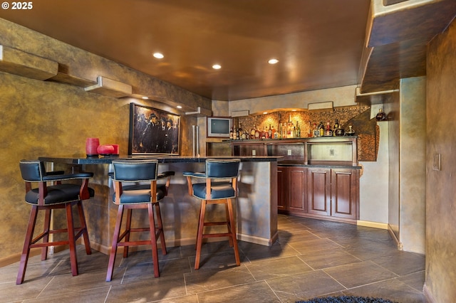 6421 Brooklake Rd, Salem, OR 97305 - indoor wet bar featuring recessed lighting, baseboards, and dark tile patterned floors