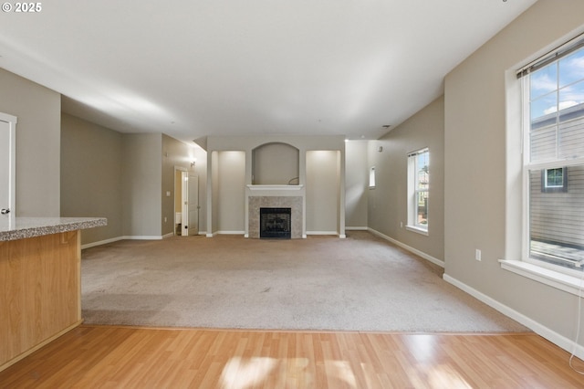 22864 SW Forest Creek Dr Unit 200, Sherwood, OR 97140 - unfurnished living room with light wood-type flooring, a fireplace, and a wealth of natural light