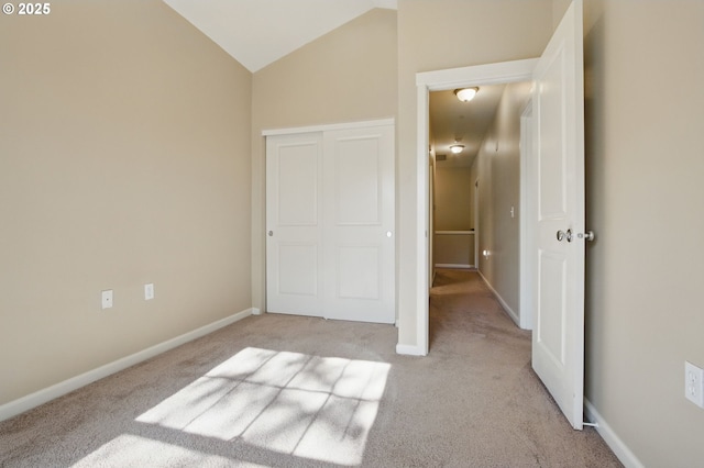 22864 SW Forest Creek Dr Unit 200, Sherwood, OR 97140 - unfurnished bedroom featuring baseboards, light carpet, vaulted ceiling, and a closet