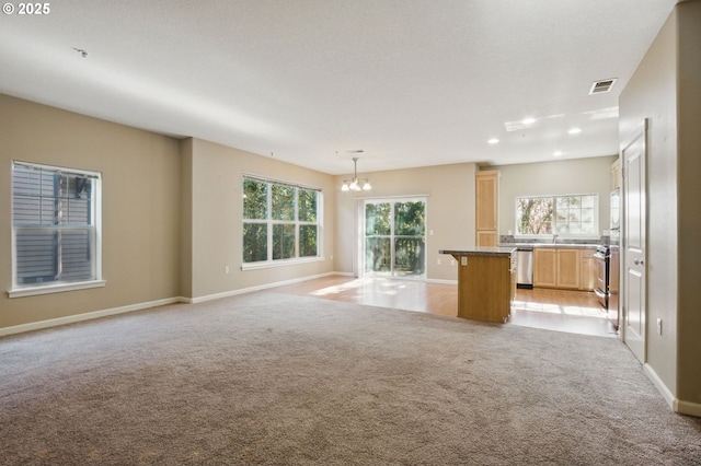 22864 SW Forest Creek Dr Unit 200, Sherwood, OR 97140 - unfurnished living room featuring a chandelier, visible vents, baseboards, and light carpet