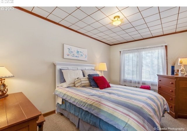 bedroom with light colored carpet, baseboards, and ornamental molding