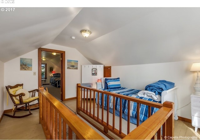 bedroom featuring baseboards and lofted ceiling