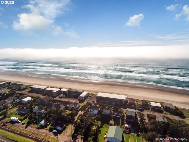 birds eye view of property featuring a view of the beach and a water view