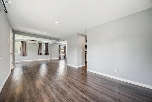 63 S 22nd St, Saint Helens, OR 97051 - unfurnished living room with a wall mounted AC, baseboards, recessed lighting, and dark wood-style flooring