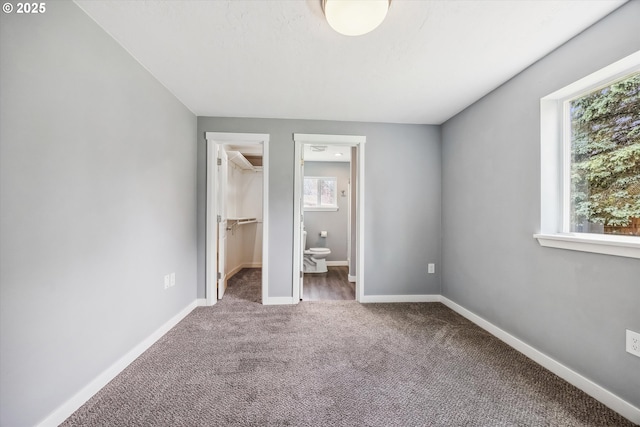 63 S 22nd St, Saint Helens, OR 97051 - unfurnished bedroom featuring carpet floors, a walk in closet, baseboards, a closet, and connected bathroom