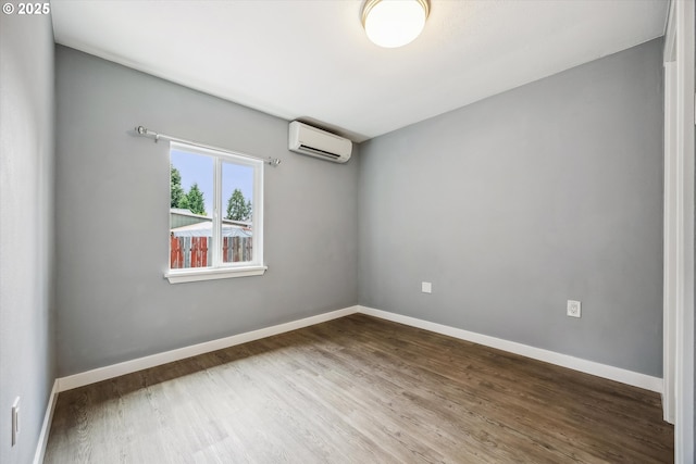63 S 22nd St, Saint Helens, OR 97051 - spare room featuring a wall mounted air conditioner, wood finished floors, and baseboards