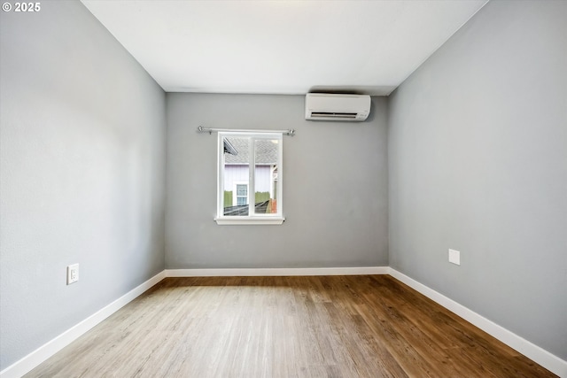 63 S 22nd St, Saint Helens, OR 97051 - spare room with an AC wall unit, wood finished floors, and baseboards