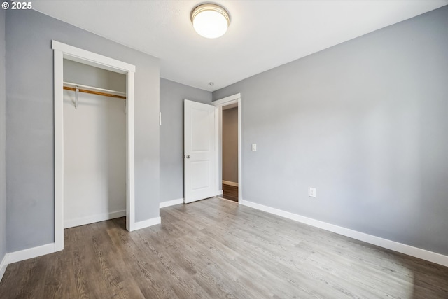 63 S 22nd St, Saint Helens, OR 97051 - unfurnished bedroom with wood finished floors, baseboards, and a closet
