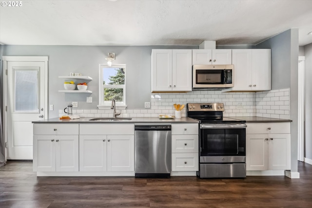 63 S 22nd St, Saint Helens, OR 97051 - kitchen with stainless steel appliances, a sink, dark countertops, and white cabinetry