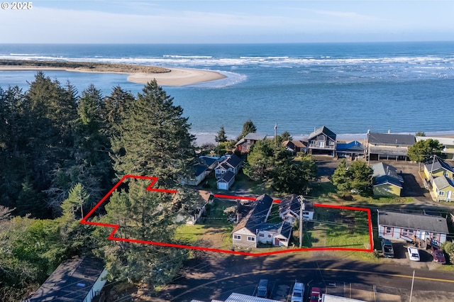 birds eye view of property with a view of the beach and a water view