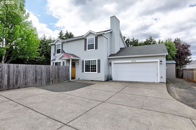 5752 SE Popes Pl, Hillsboro, OR 97123 - traditional-style house with driveway, a garage, fence, and a chimney