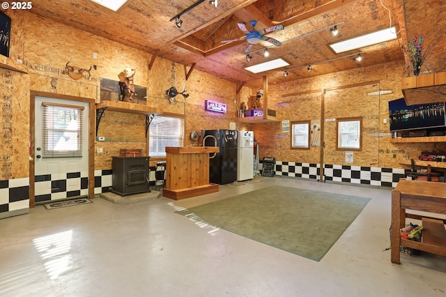 39100 SE Tumala Mountain Rd, Estacada, OR 97023 - garage with a wood stove and freestanding refrigerator