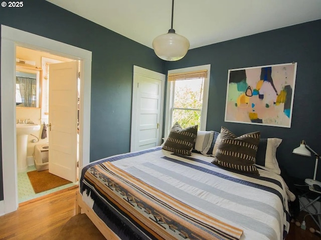 1236 N Emerson St, Portland, OR 97217 - bedroom with light wood-style floors and ensuite bath