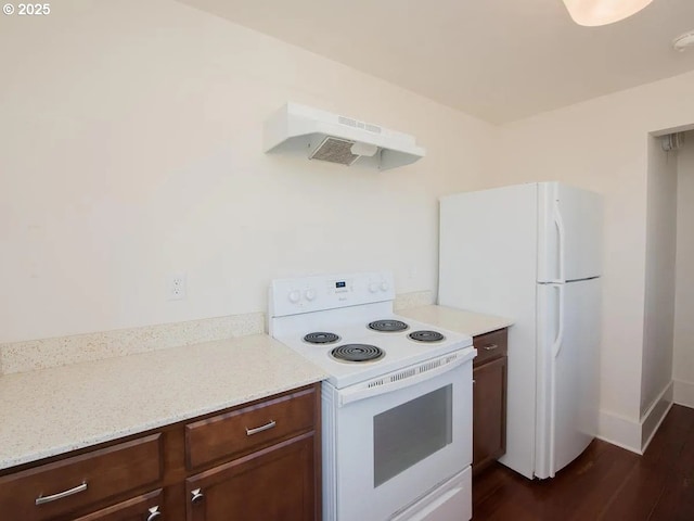 1236 N Emerson St, Portland, OR 97217 - kitchen with white appliances, under cabinet range hood, dark wood-style floors, baseboards, and light stone counters