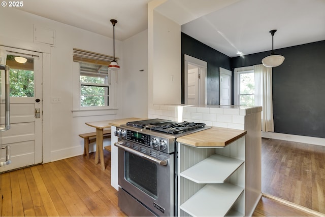 1236 N Emerson St, Portland, OR 97217 - kitchen with high end stove, light wood-type flooring, baseboards, wooden counters, and open shelves