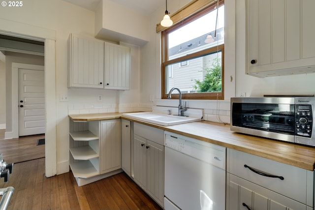 1236 N Emerson St, Portland, OR 97217 - kitchen with white dishwasher, butcher block countertops, a sink, open shelves, and dark wood-style flooring