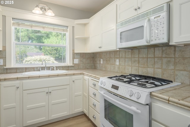 1507 Bogart Ln, Eugene, OR 97401 - kitchen featuring white appliances, white cabinets, tile counters, and backsplash