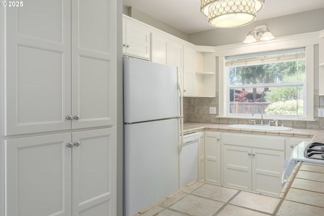 1507 Bogart Ln, Eugene, OR 97401 - kitchen featuring white appliances, open shelves, tile countertops, tasteful backsplash, and white cabinets