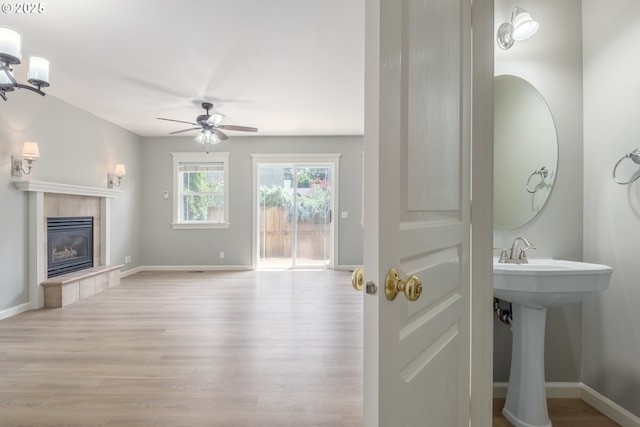 1507 Bogart Ln, Eugene, OR 97401 - bathroom featuring wood finished floors, a tiled fireplace, and ceiling fan