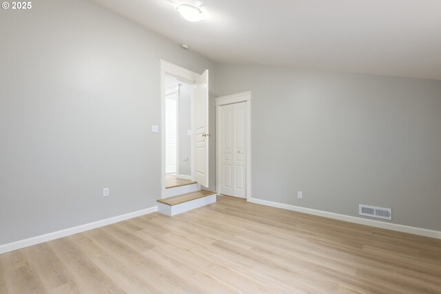 1507 Bogart Ln, Eugene, OR 97401 - spare room featuring light wood-style flooring and lofted ceiling