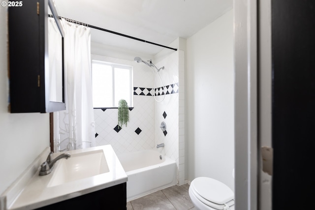 bathroom featuring toilet, shower / bath combination with curtain, and vanity