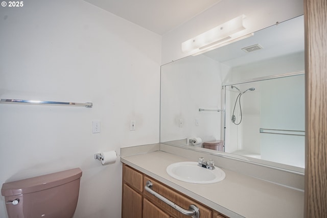 full bathroom with visible vents, vanity, toilet, and walk in shower