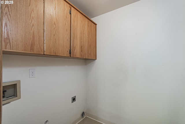 clothes washing area with baseboards, washer hookup, cabinet space, and hookup for an electric dryer