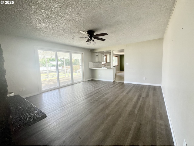 940 W Madrona Ave, Hermiston, OR 97838 - unfurnished living room featuring ceiling fan, dark wood-style flooring, and a textured ceiling