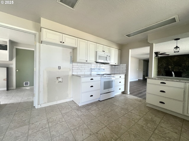 940 W Madrona Ave, Hermiston, OR 97838 - kitchen with white appliances, a textured ceiling, backsplash, white cabinets, and ceiling fan