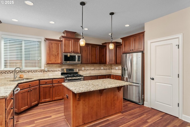 14727 Purple Ash Way, Oregon City, OR 97045 - kitchen featuring appliances with stainless steel finishes, a sink, dark wood-style floors, backsplash, and recessed lighting
