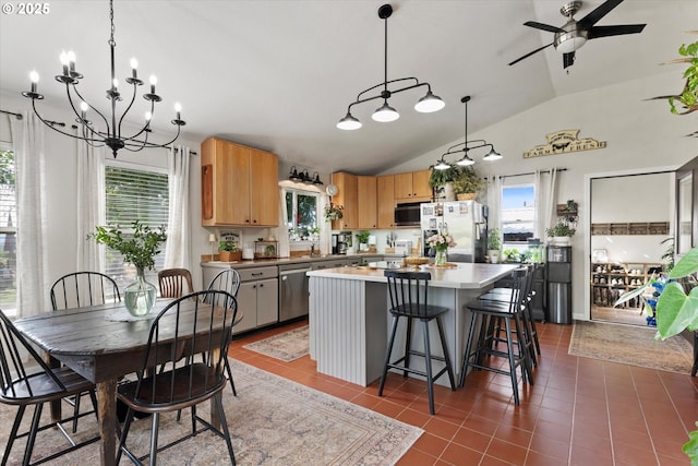 69768 Hwy 237, Cove, OR 97824 - kitchen with stainless steel appliances, healthy amount of natural light, a kitchen island, vaulted ceiling, and light countertops