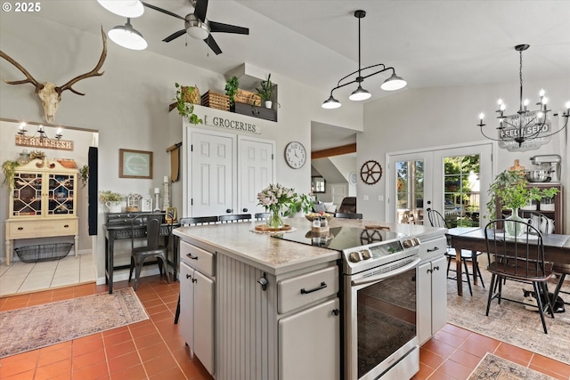 69768 Hwy 237, Cove, OR 97824 - kitchen featuring stainless steel range with electric cooktop, dark tile patterned floors, ceiling fan, french doors, and light countertops