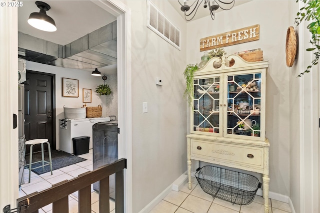 69768 Hwy 237, Cove, OR 97824 - hall featuring light tile patterned floors, baseboards, and a chandelier