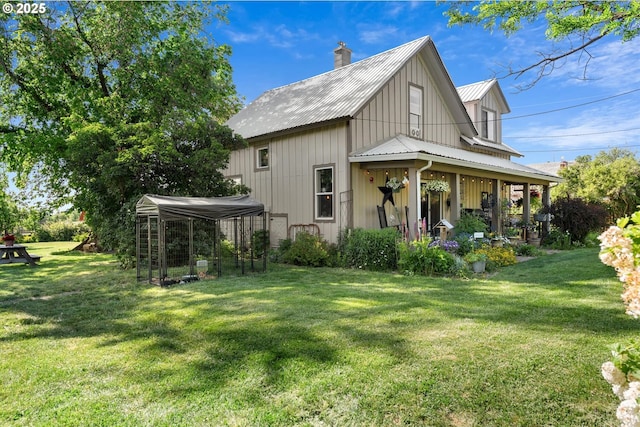69768 Hwy 237, Cove, OR 97824 - back of property with metal roof, a chimney, and a lawn