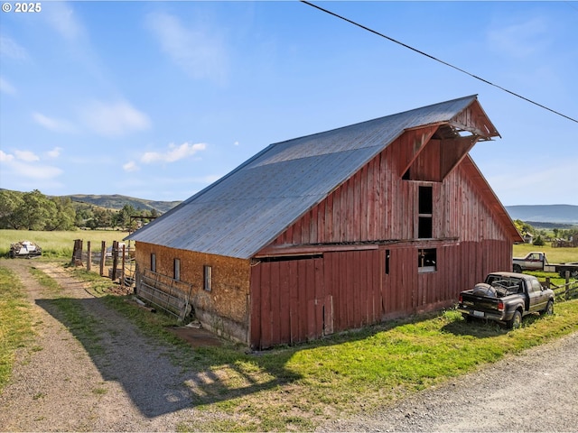 69768 Hwy 237, Cove, OR 97824 - view of property exterior with a barn, an outbuilding, dirt driveway, and a mountain view