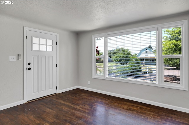 1119 7th St, Springfield, OR 97477 - entryway featuring dark wood finished floors, baseboards, and a textured ceiling