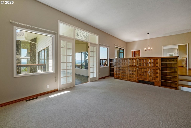 3794 E Nanitch Cir S, Salem, OR 97306 - unfurnished living room featuring a chandelier, carpet flooring, and baseboards