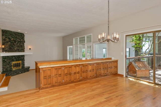 3794 E Nanitch Cir S, Salem, OR 97306 - dining space featuring a chandelier, light wood-style floors, and a fireplace