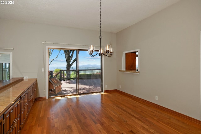 3794 E Nanitch Cir S, Salem, OR 97306 - unfurnished dining area featuring a chandelier, wood finished floors, and baseboards