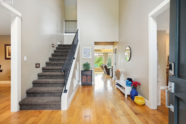 152 Palos Verdes, White Salmon, WA 98672 - entryway with stairway, light wood-style flooring, a towering ceiling, and baseboards
