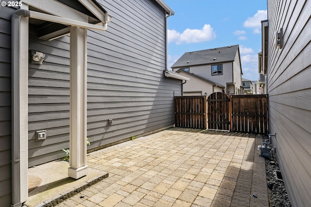 view of patio featuring a gate and fence