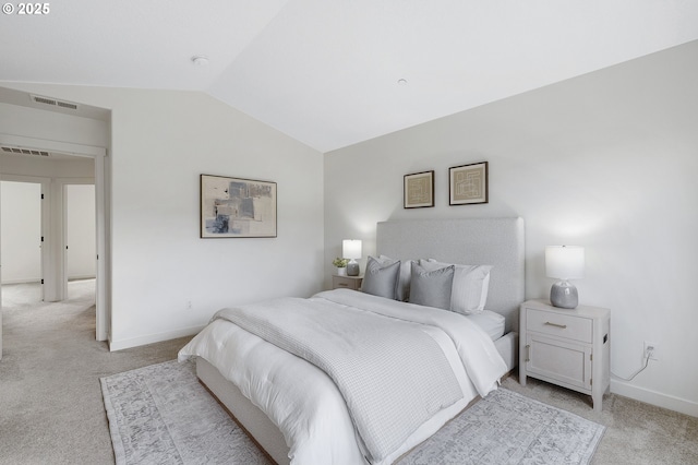 bedroom featuring lofted ceiling, baseboards, light carpet, and visible vents