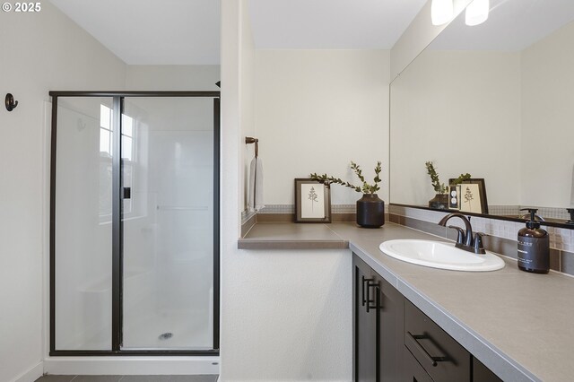 bathroom with a stall shower and vanity