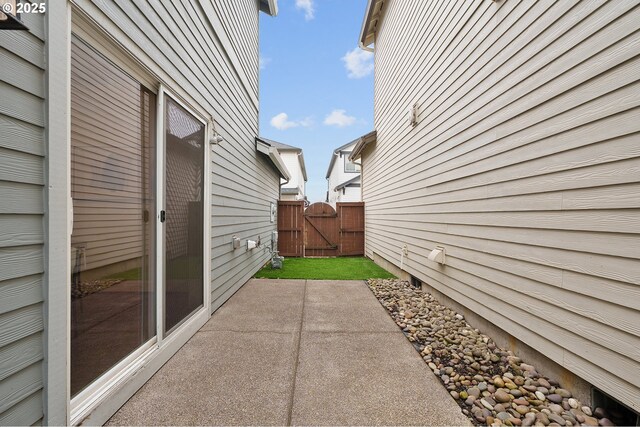 view of patio featuring a gate and fence