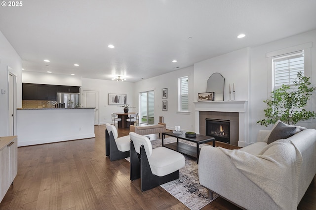 living room with recessed lighting, a fireplace, dark wood finished floors, and baseboards