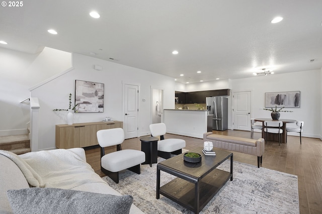 living area with stairs, baseboards, wood finished floors, and recessed lighting