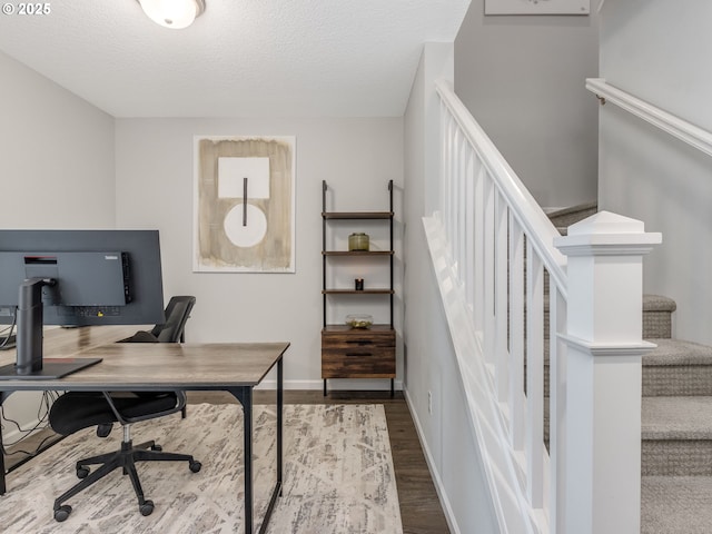 home office featuring hardwood / wood-style flooring and a textured ceiling